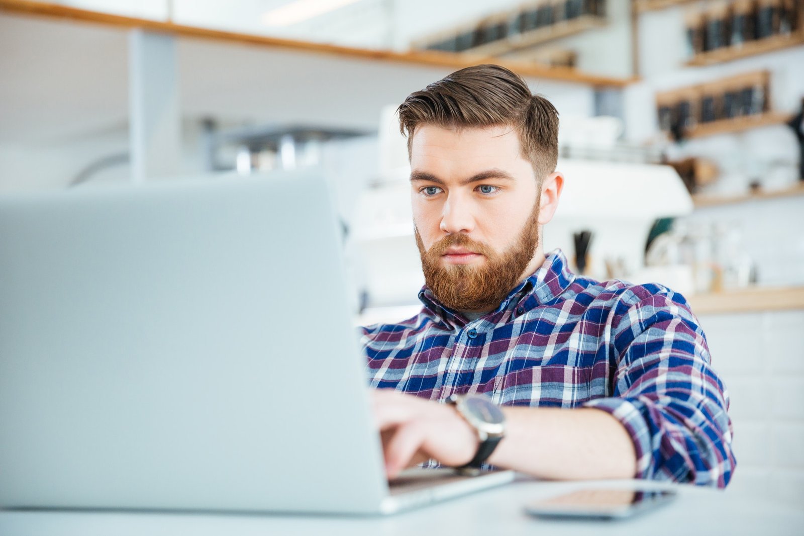 Man using laptop computer in cafe
